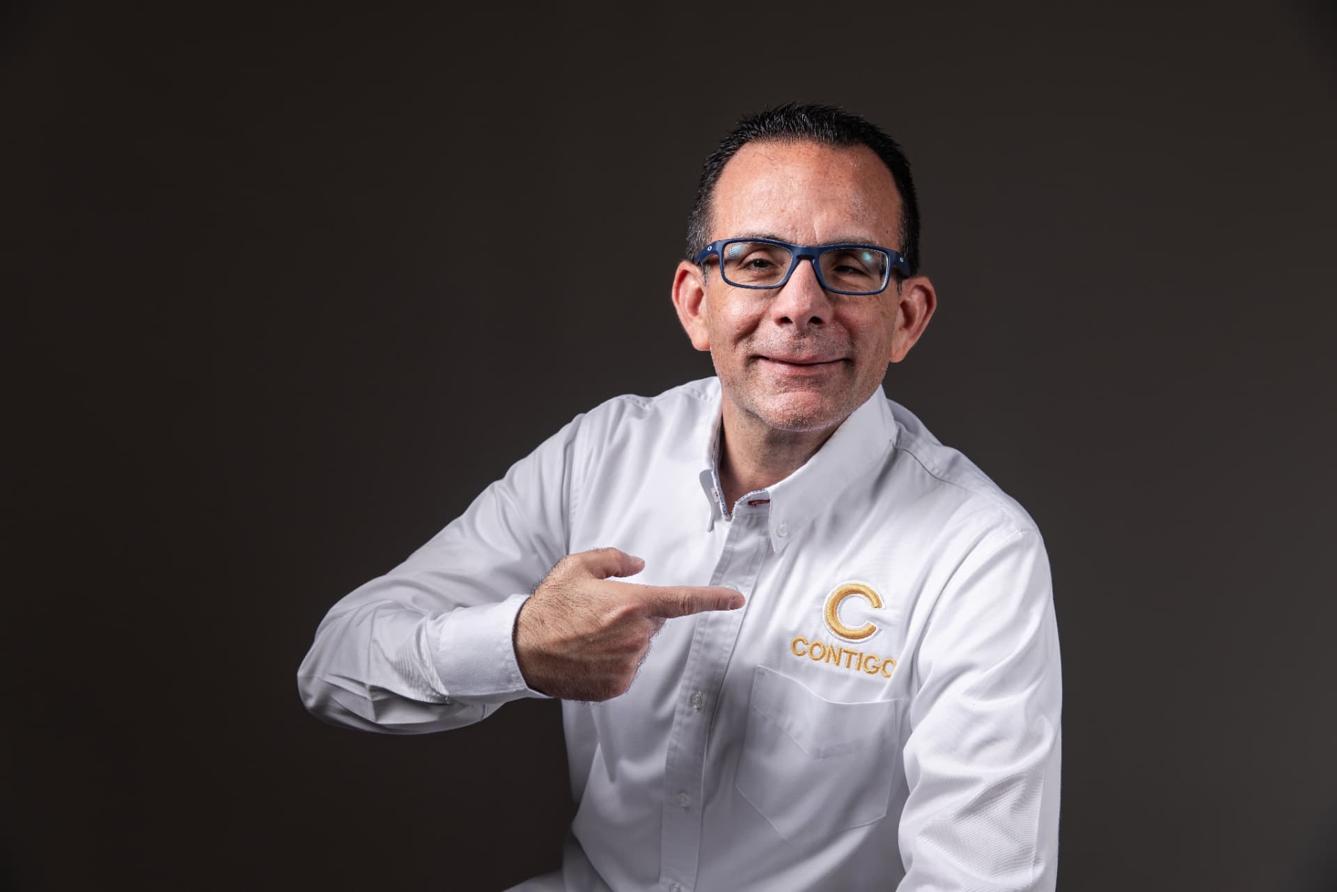 Christian Doig señalando el bordado de Contigo en su camisa